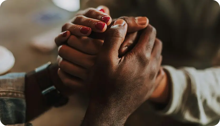 someone holding a persons hand with a red nail polish